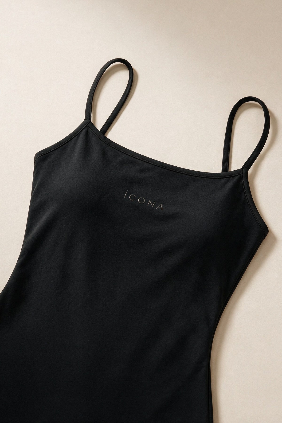 The Signature One Piece in Black, packshot fabric and logo