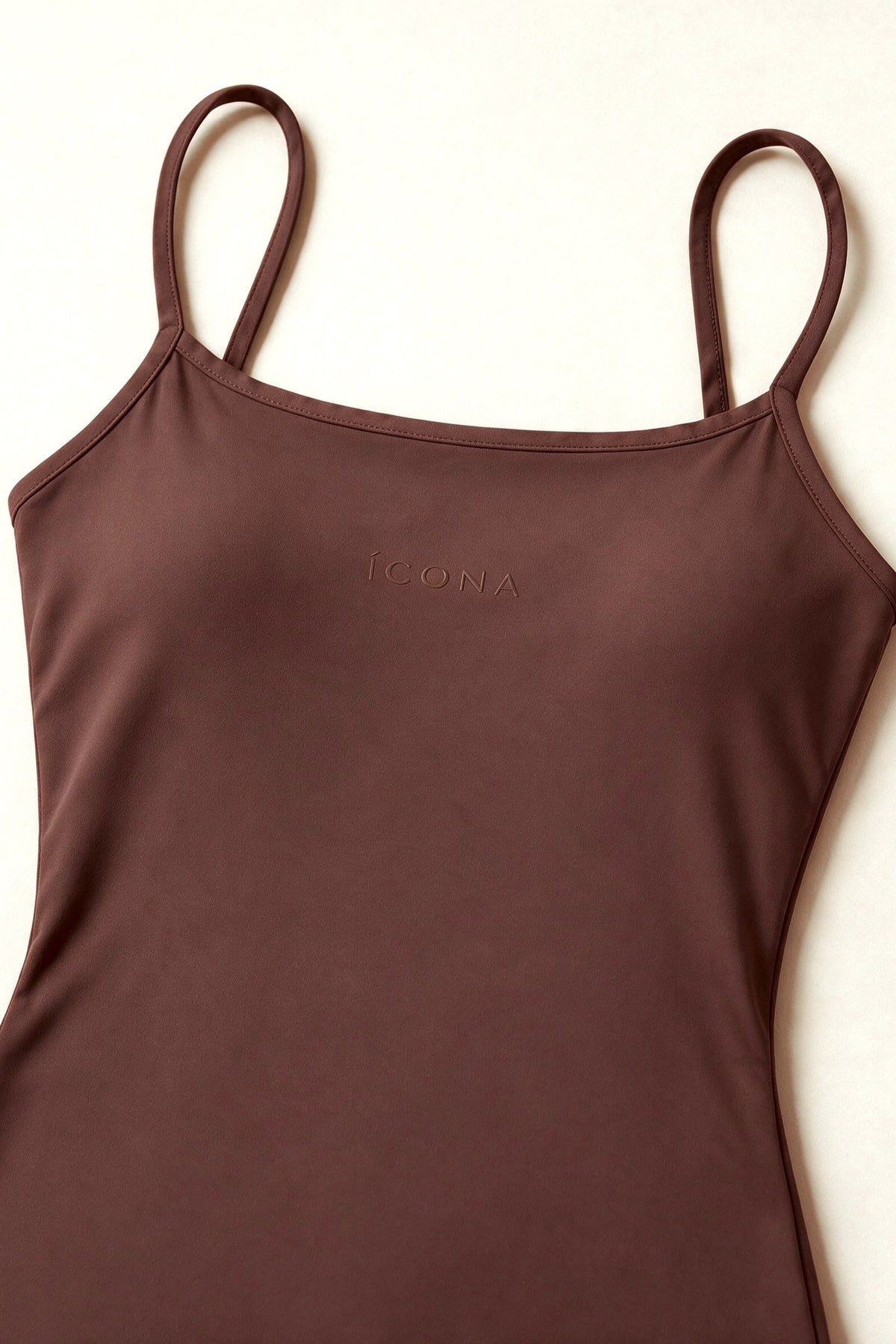 The Signature One Piece in Brown, packshot fabric and logo